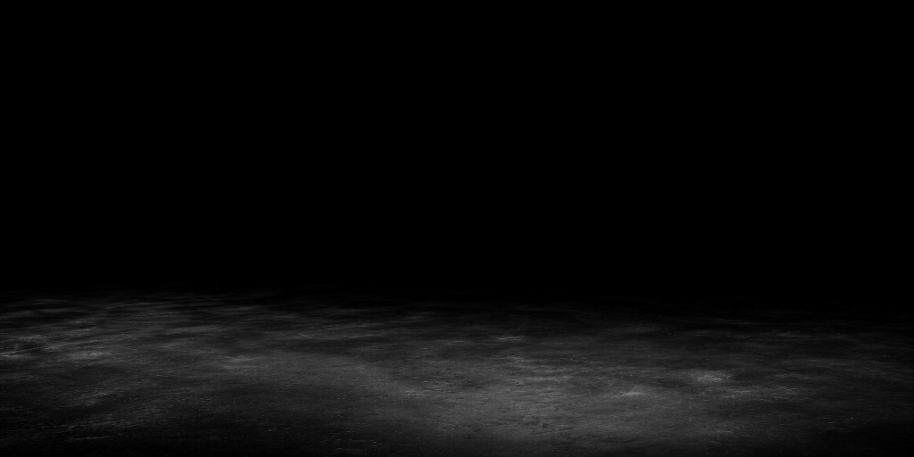 Dark studio floor fading into black